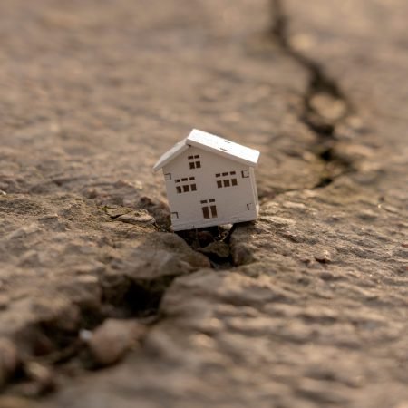 house-fell-into-crack-during-earthquake-earthquake-home-insurance-concept-real-estate-fall